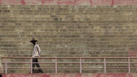 A man wearing a traditional hat arrives at a rally in support of the ruling military junta, attended by roughly 1,000 people in a stadium with a capacity of 50,000, in Bamako, Mali