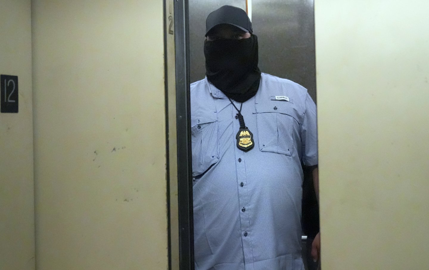A masked ICE agent stalks the corridors on the 12th floor of Lower Manhattan’s immigration court at 26 Federal Plaza, New York City on September 8, 2025.